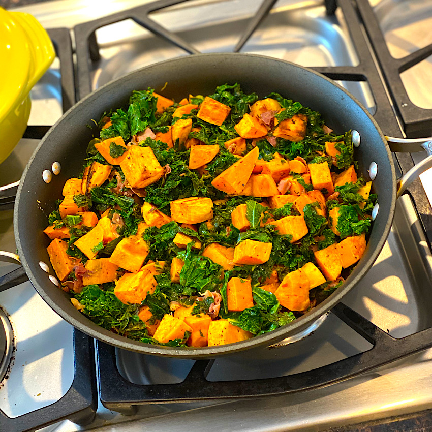 sweet potatoes and kale in a large skillet