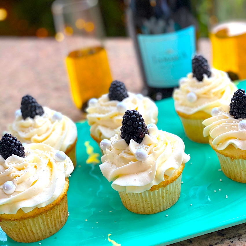 Blackberry Prosecco Cupcakes with Prosecco in background