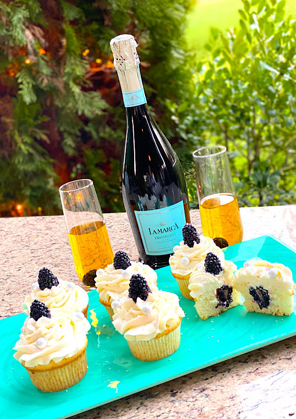 Blackberry Prosecco Cupcakes with Prosecco in the background