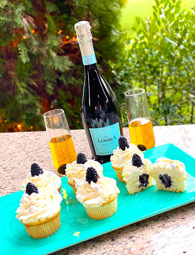 Blackberry Prosecco Cupcakes with Prosecco in the background