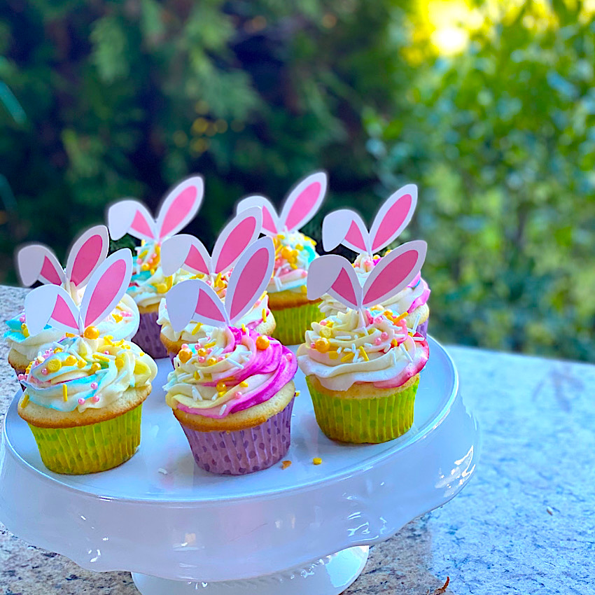 Easter Almond Cake with Almond Buttercream Icing made into cupcakes on a cake stand.