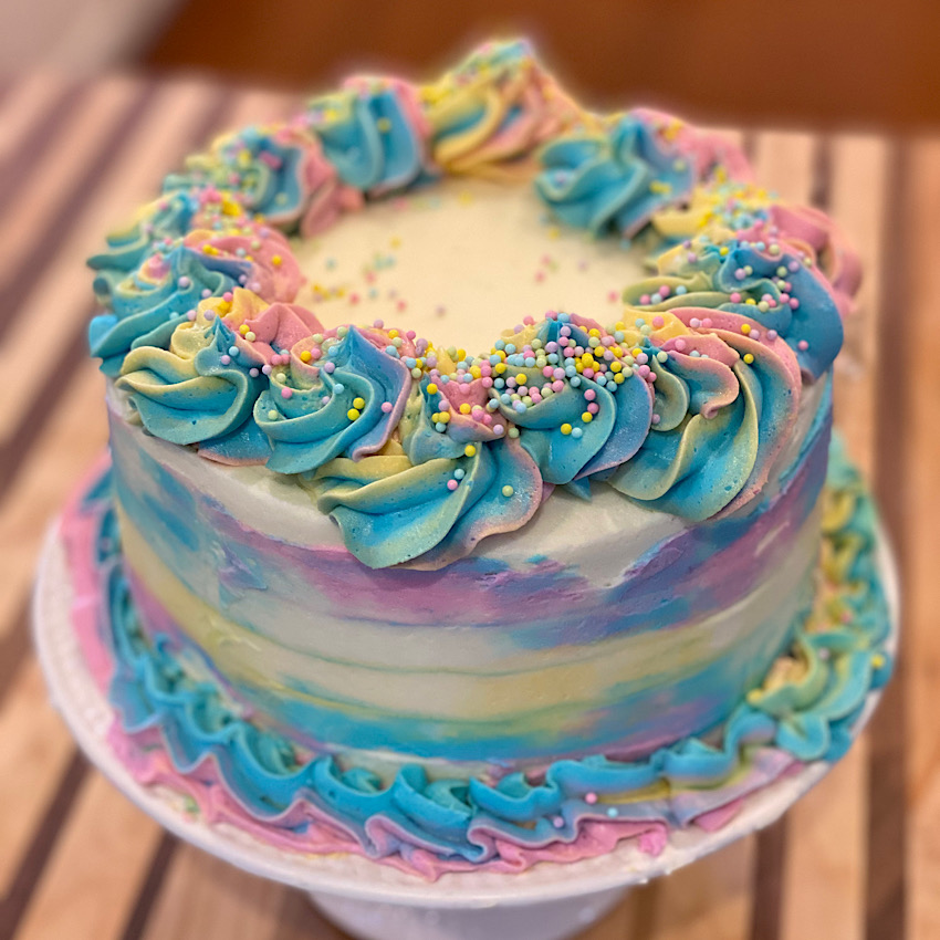 Easter Almond Cake with Almond Buttercream Icing iced in Spring Colored icing just in time for Easter.