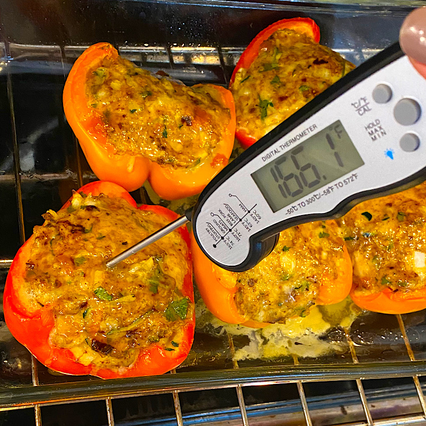 Checking the temperatures of the Southwest Stuffed Peppers to make sure they are finished cooking.