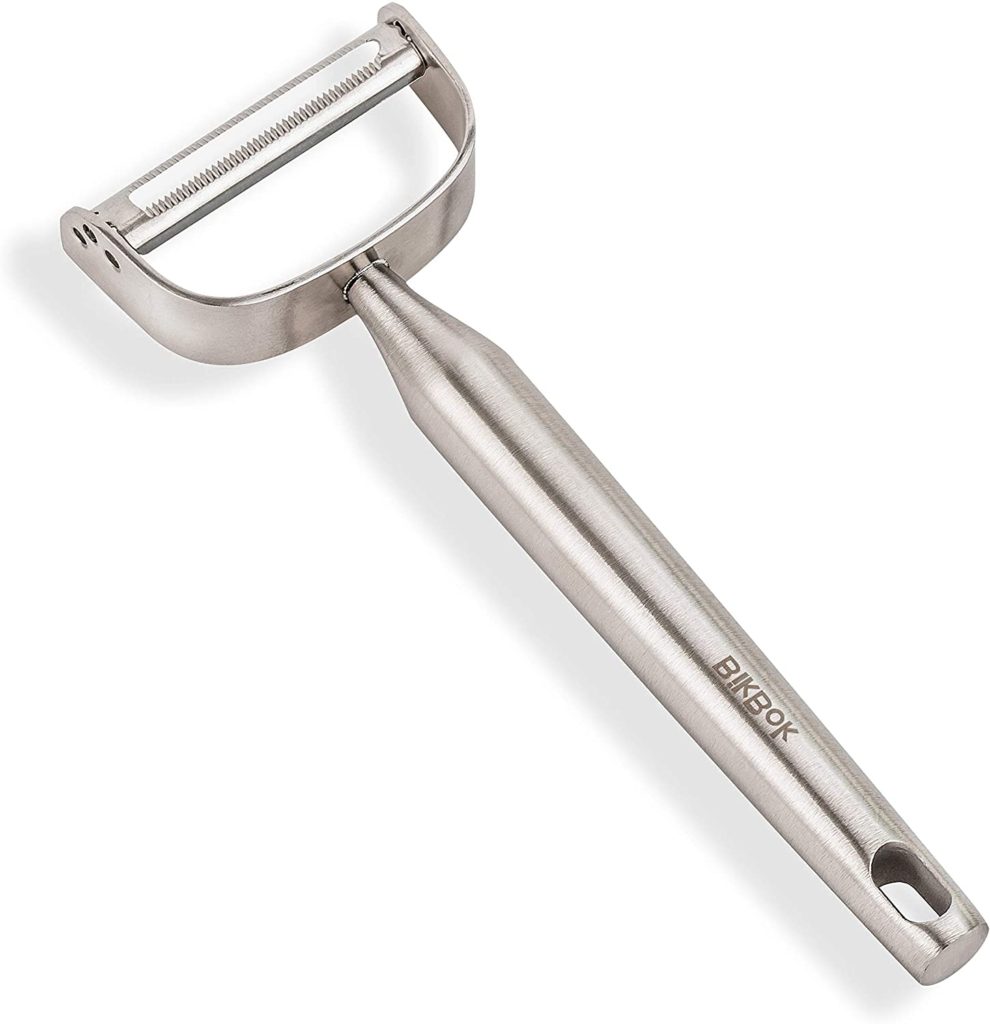 A stainless steel serrated peeler.