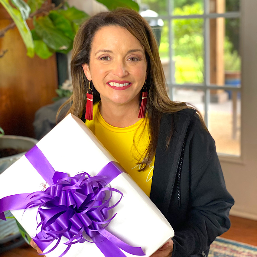 Lara holding a gift box adorned with a beautiful Handmade Bow