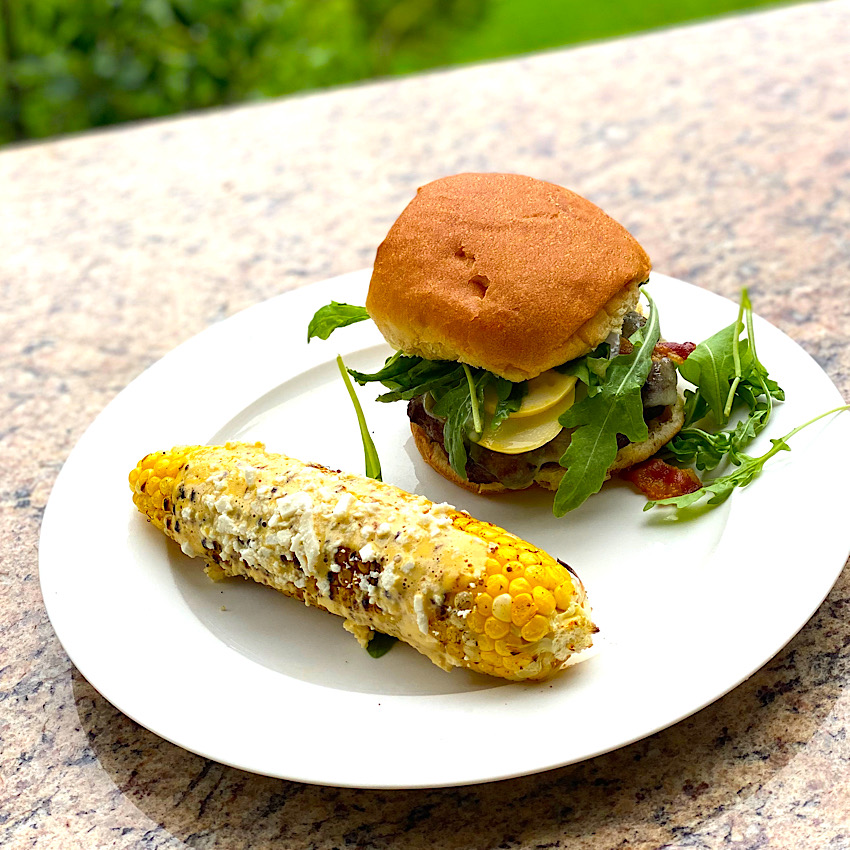 Bayou Burger from Grill of Victory with the Cajun Grilled Corn from Grill of Victory ready to eat