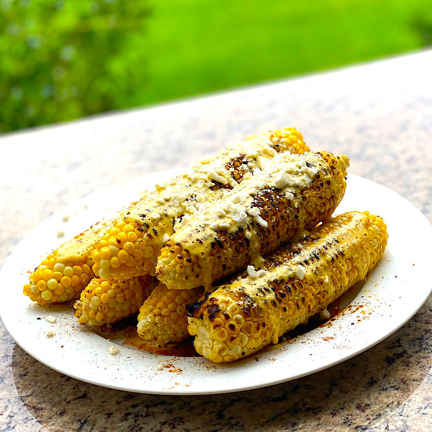Cajun Grilled Corn from Grill of Victory piled high on a plate ready to serve