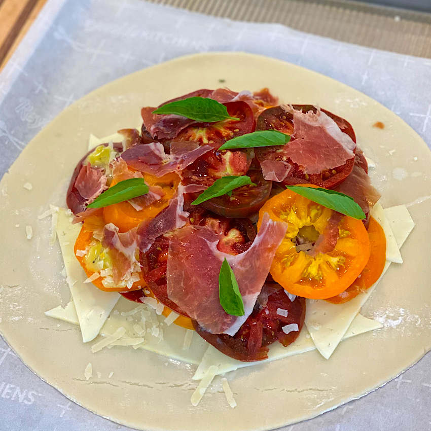 Fresh Basil on top of the layers in the Rustic Tomato Tart.