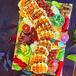Gluten-Free Waffle Board filled with all sorts of Savory toppings decorated for Fall