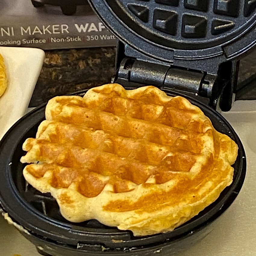 Waffle that has just finished cooking in the waffle maker