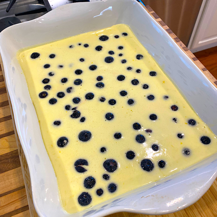 Adding the fresh blueberries to the lemon filling. Before baking a second time.