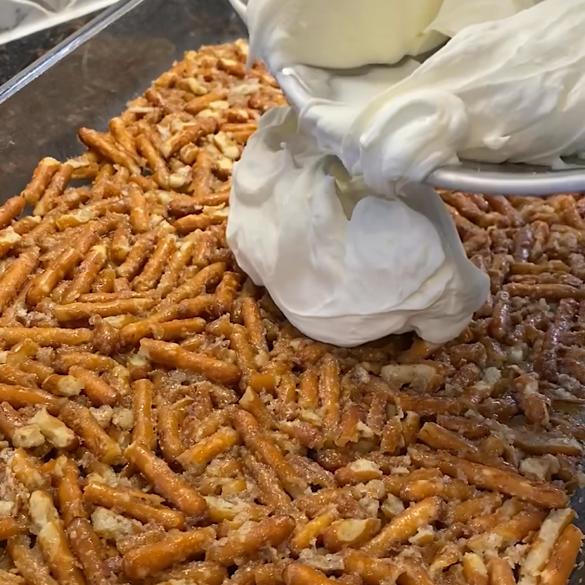 Photo of crunchy pretzel layer. And adding cream filling.