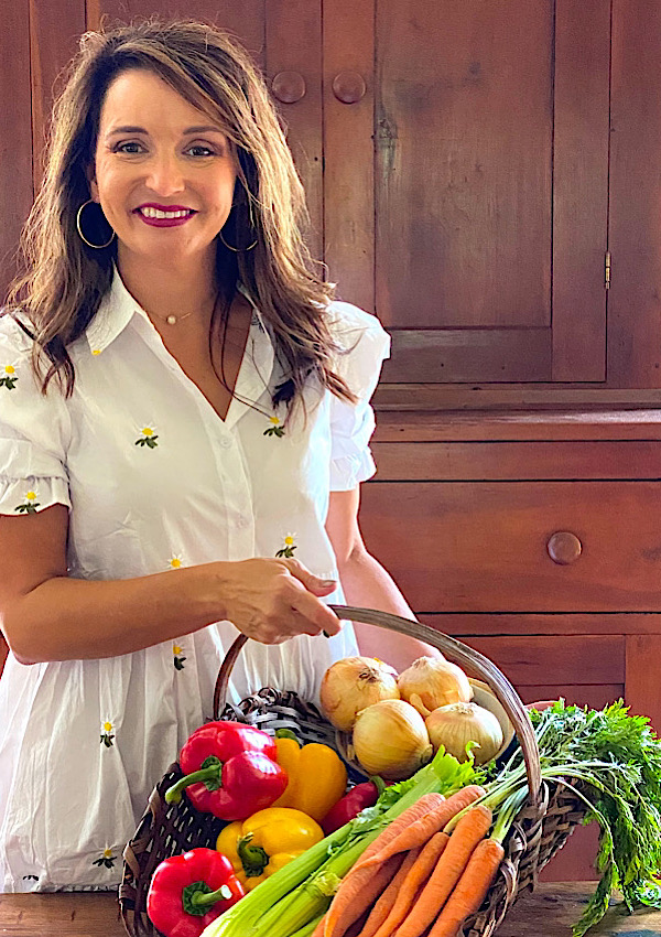 Photo of Lara with a basket of vegetables